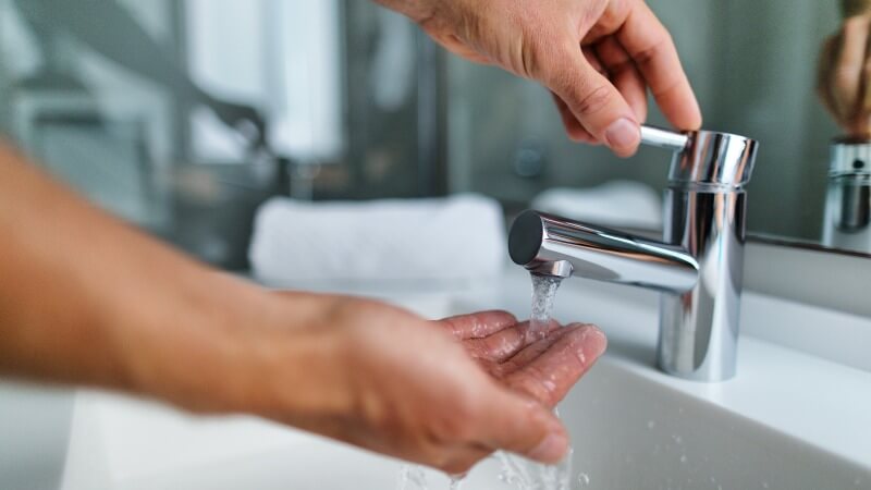 employee-using-tap-at-sink