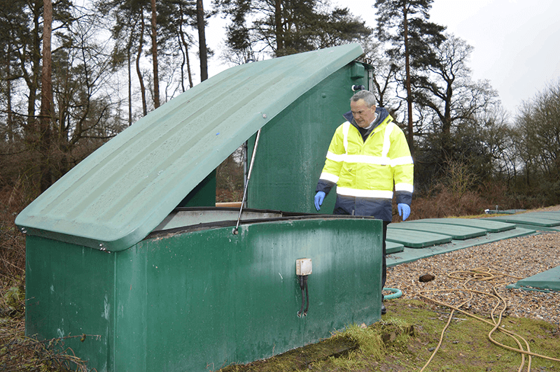 Technical-director-Andrew-Baird-inspects-v-notch-weir-flow-splitter-of-wastewater-treatment-plant 800px