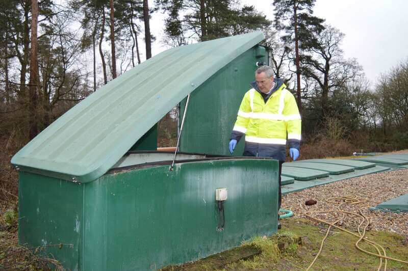 Technical-director-Andrew-Baird-inspects-v-notch-weir-flow-splitter-of-wastewater-treatment-plant